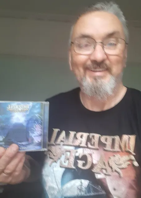 A fan in an Imperial Age shirt holding the CD