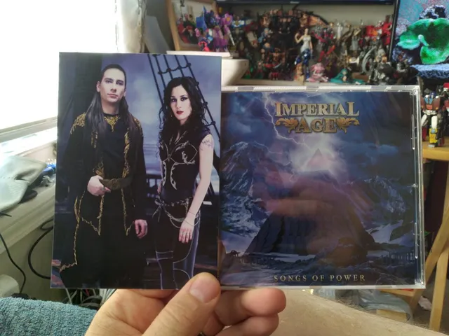 A fan holding the CD and the band card
